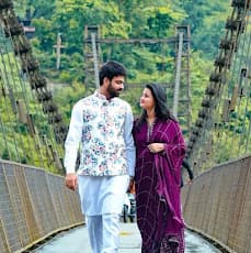 Couple walking on suspension bridge