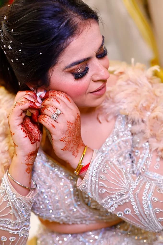 Bride close-up with mehendi and bridal lehenga