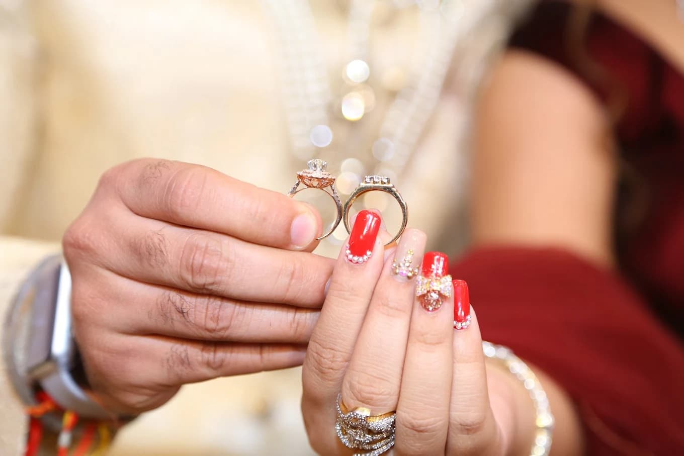 Couple holding engagement rings