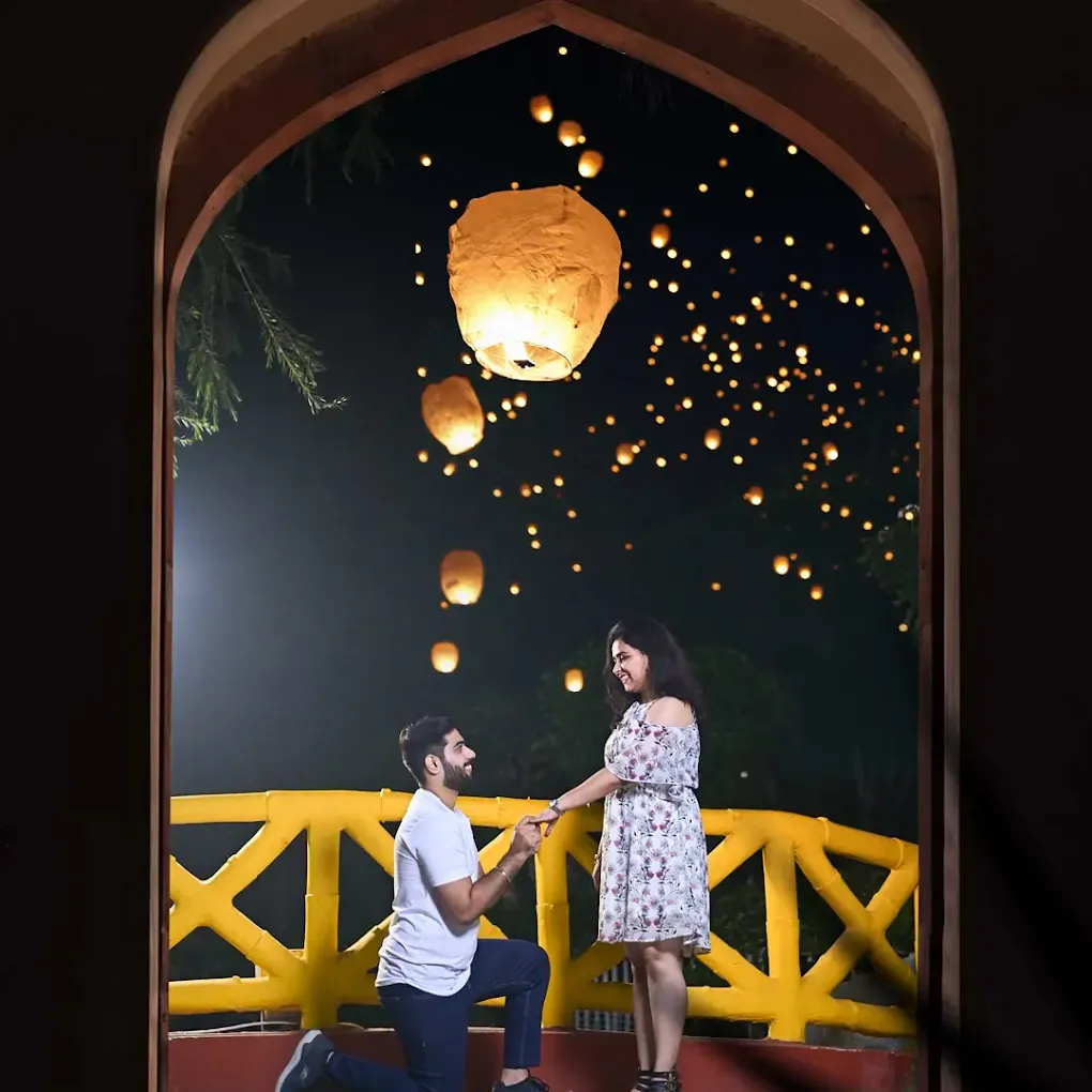 Romantic proposal with sky lanterns at night